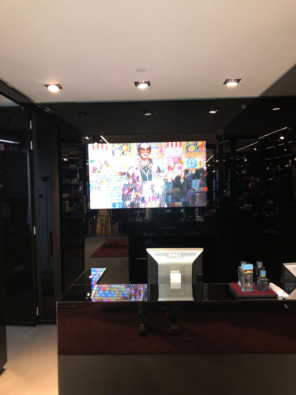 A large flat screen tv is on the wall above a desk