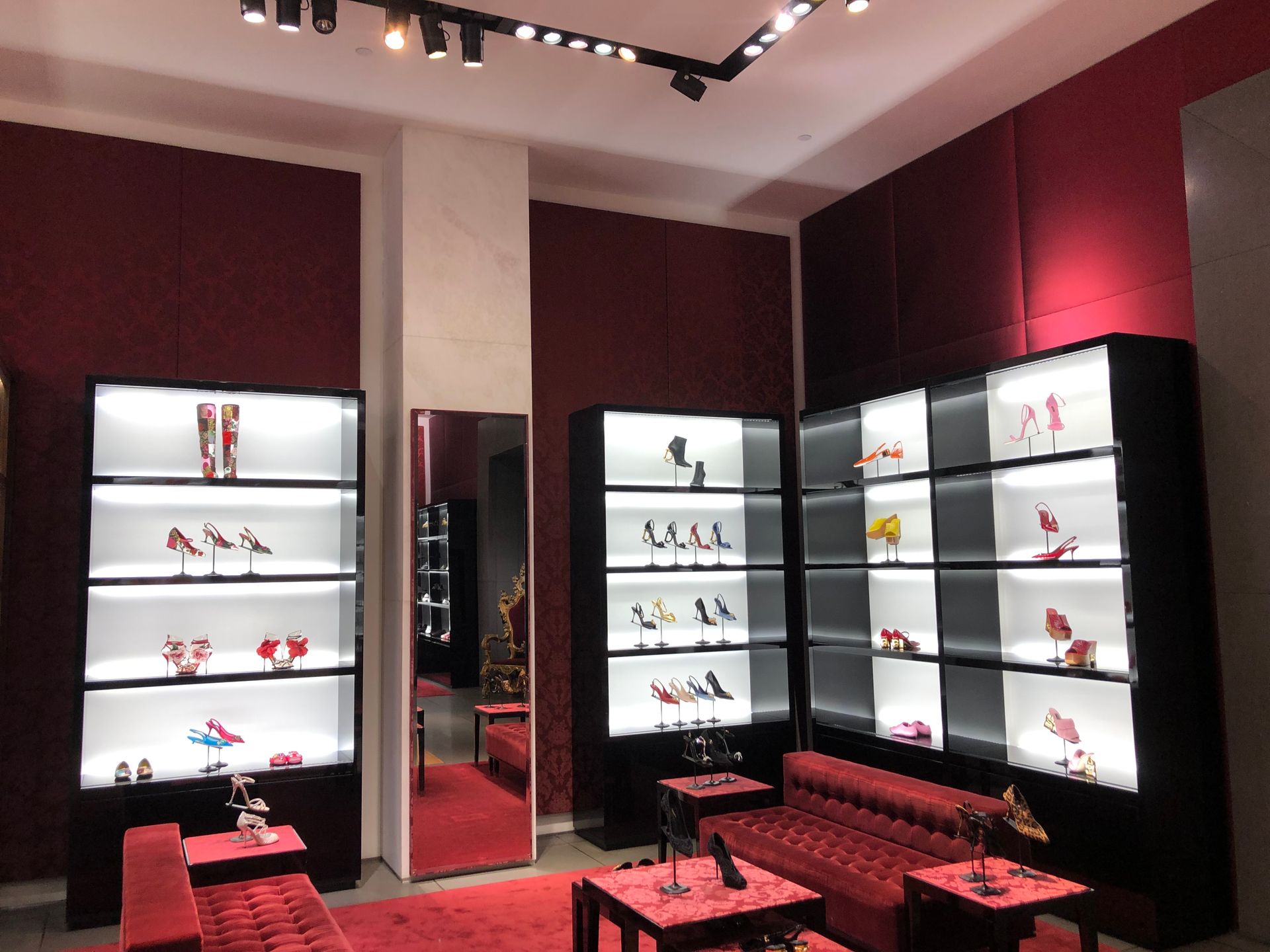 A store filled with lots of shoes and a couch