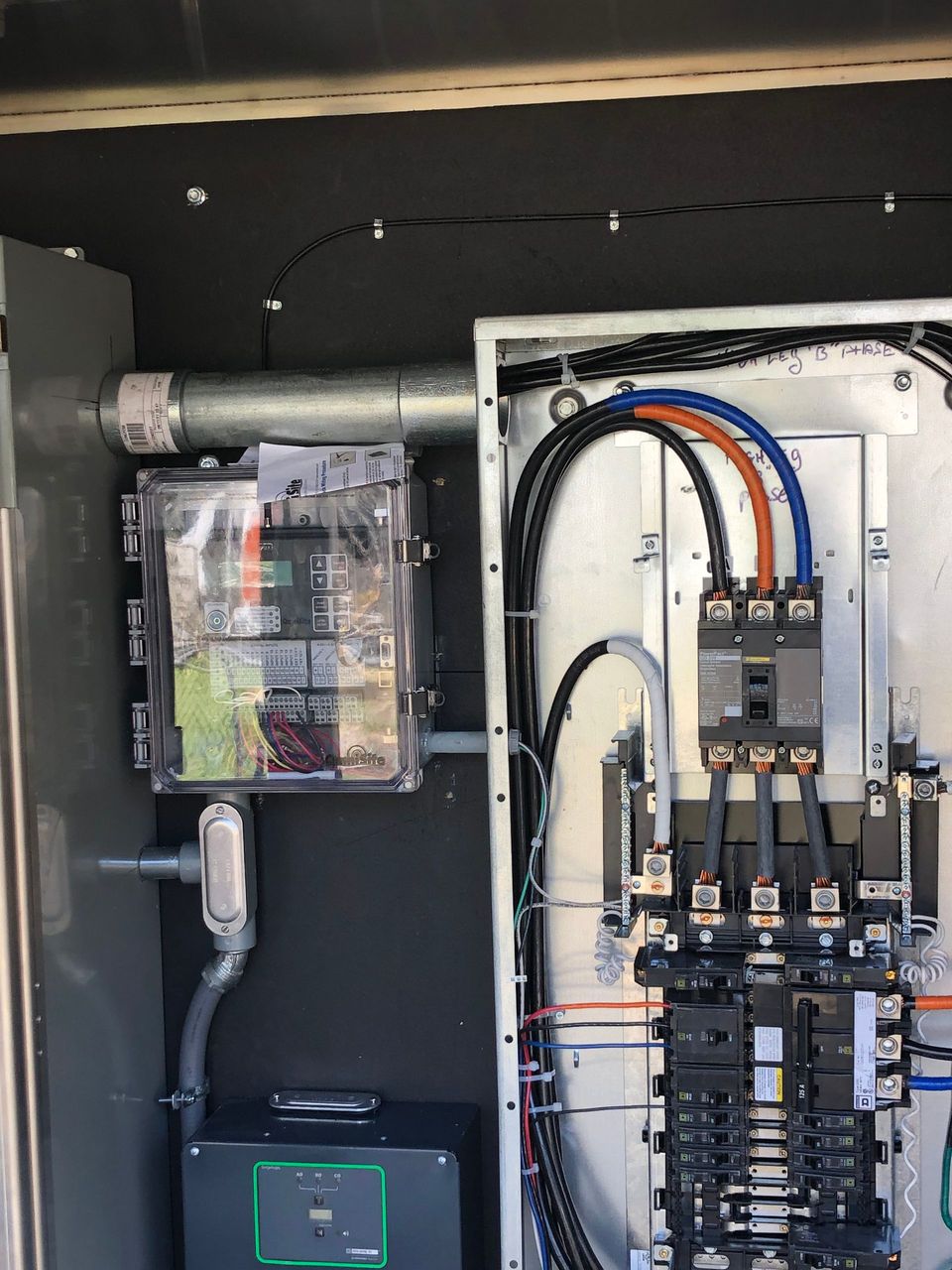 A close up of a electrical box with wires coming out of it