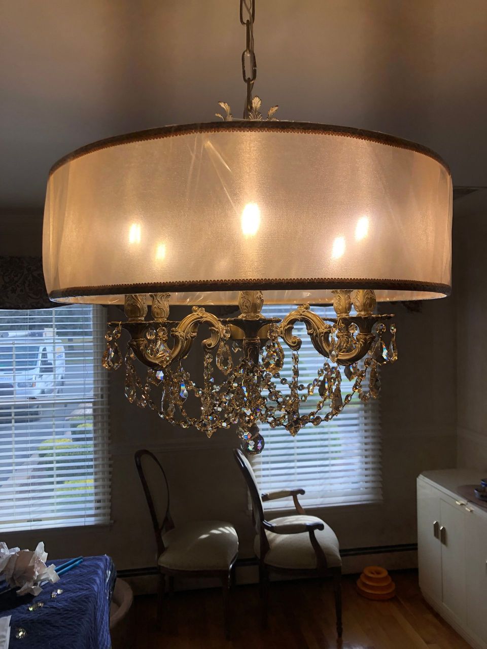 A chandelier is hanging from the ceiling in a living room