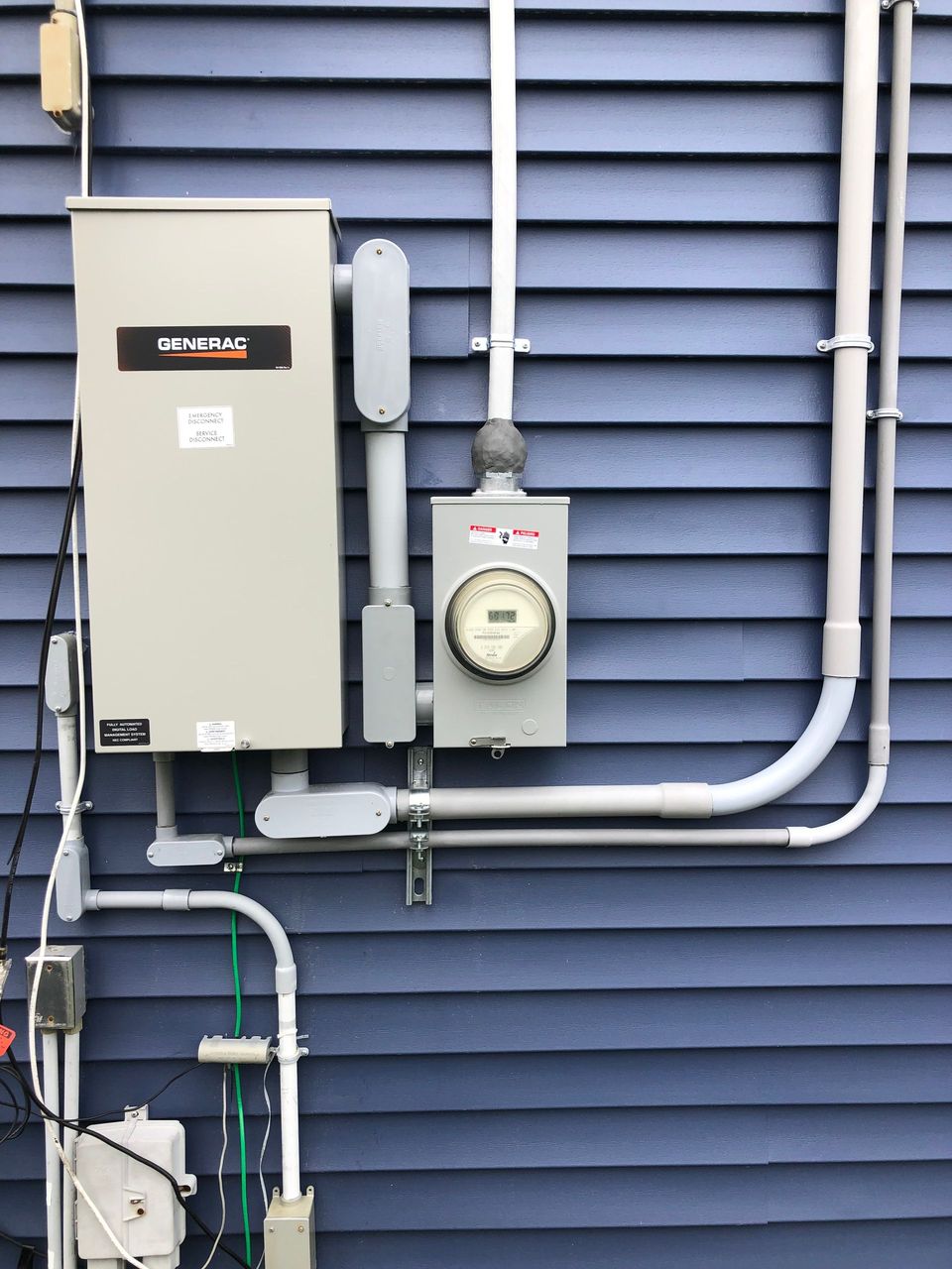 There is a meter on the side of a building.