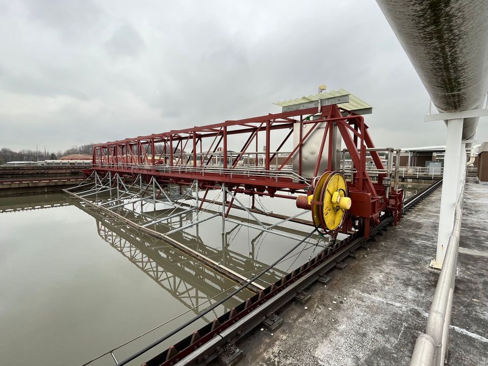A red and yellow bridge over a body of water.