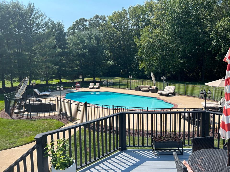 A view of a large swimming pool from a deck.
