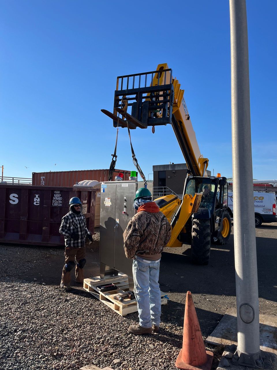 A man is using a forklift to lift a box
