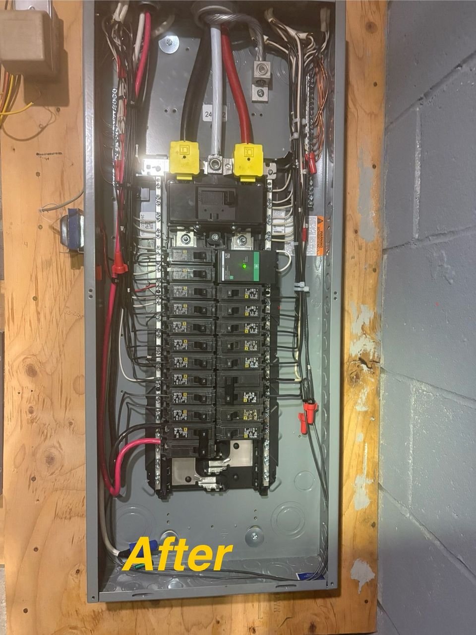 Open electrical breaker panel in a wall cavity, labeled “After.”