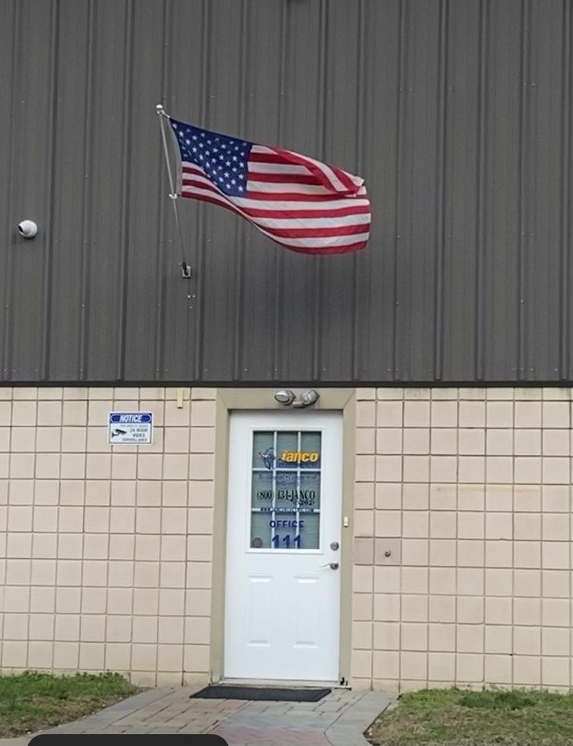 An american flag is flying in front of a building
