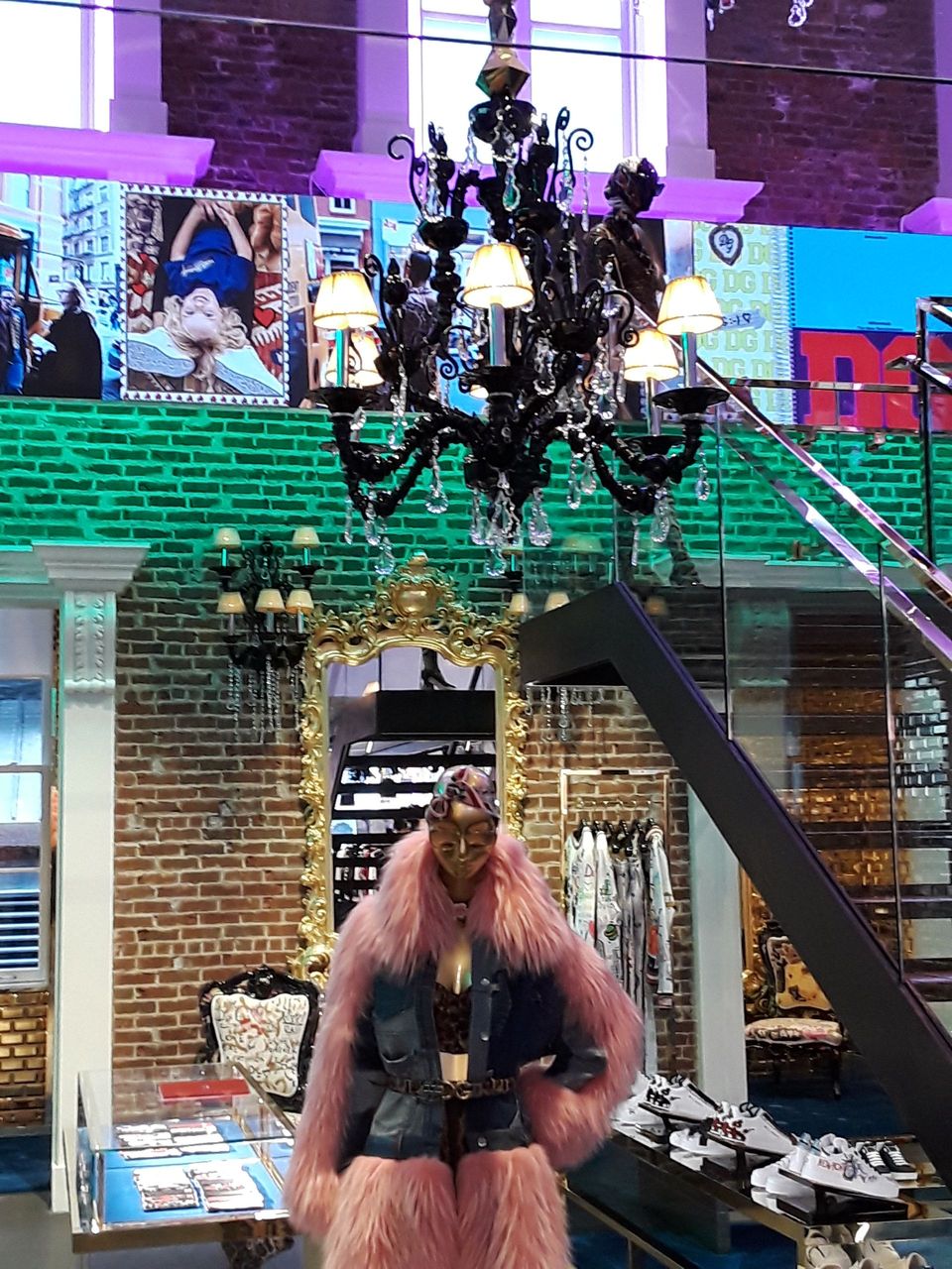 A woman in a pink fur coat is standing in a store