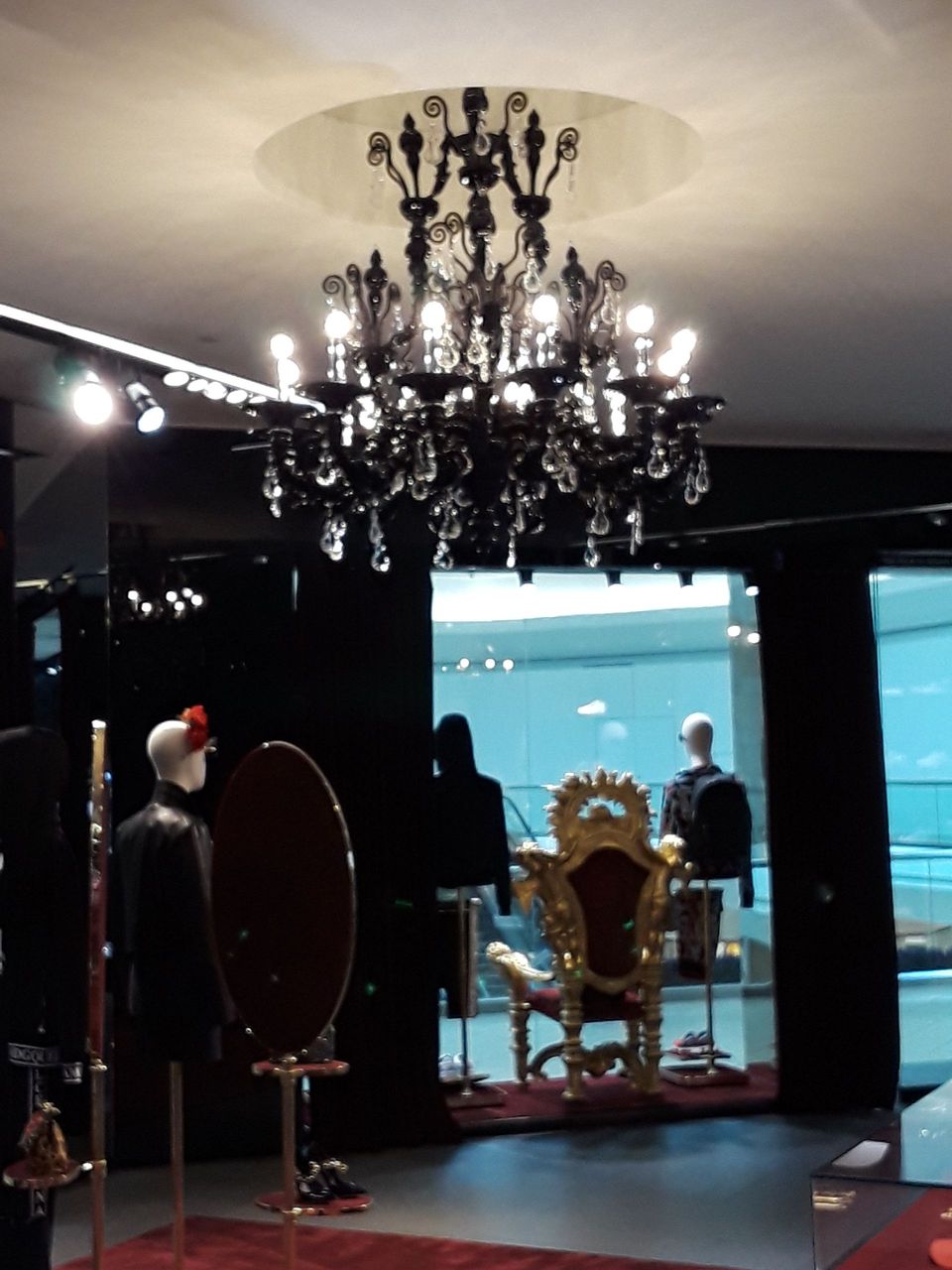 A room with a chandelier hanging from the ceiling