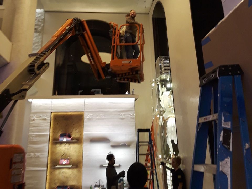 A man is working on a lift in a store