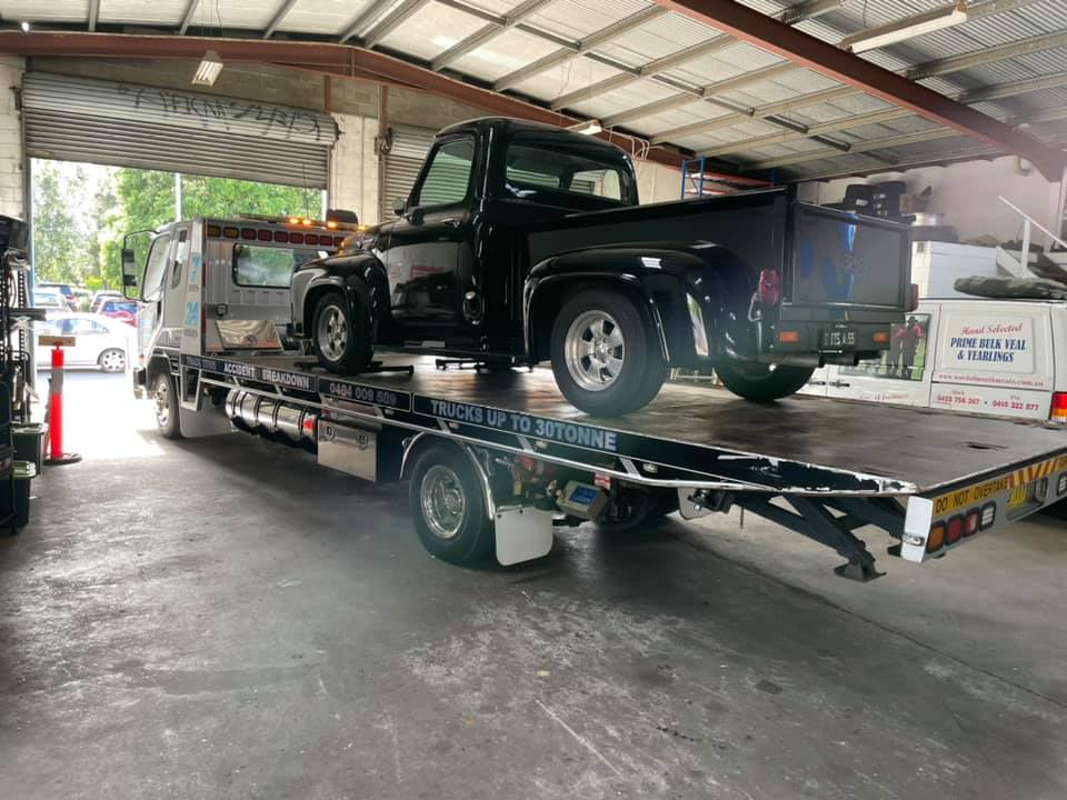 Black Vintage Car on a Tow Truck — Towing in Kempsey
