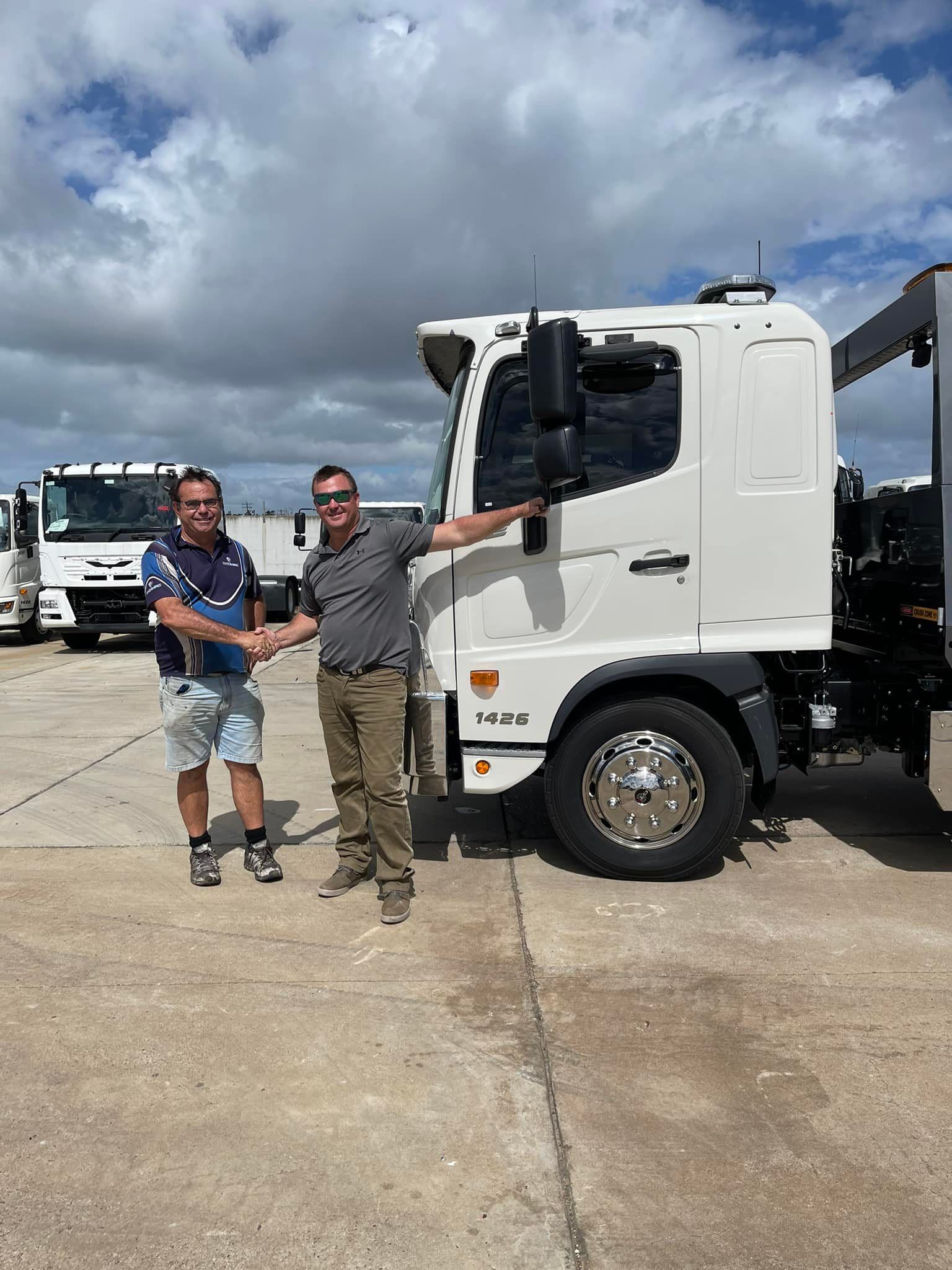 Two Men Handshaking with Truck Beside Them — Brocky’s Towing & Tilt Tray in Kempsey, NSW