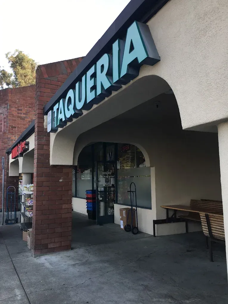 A brick building with a sign that says ' taqueria ' on it