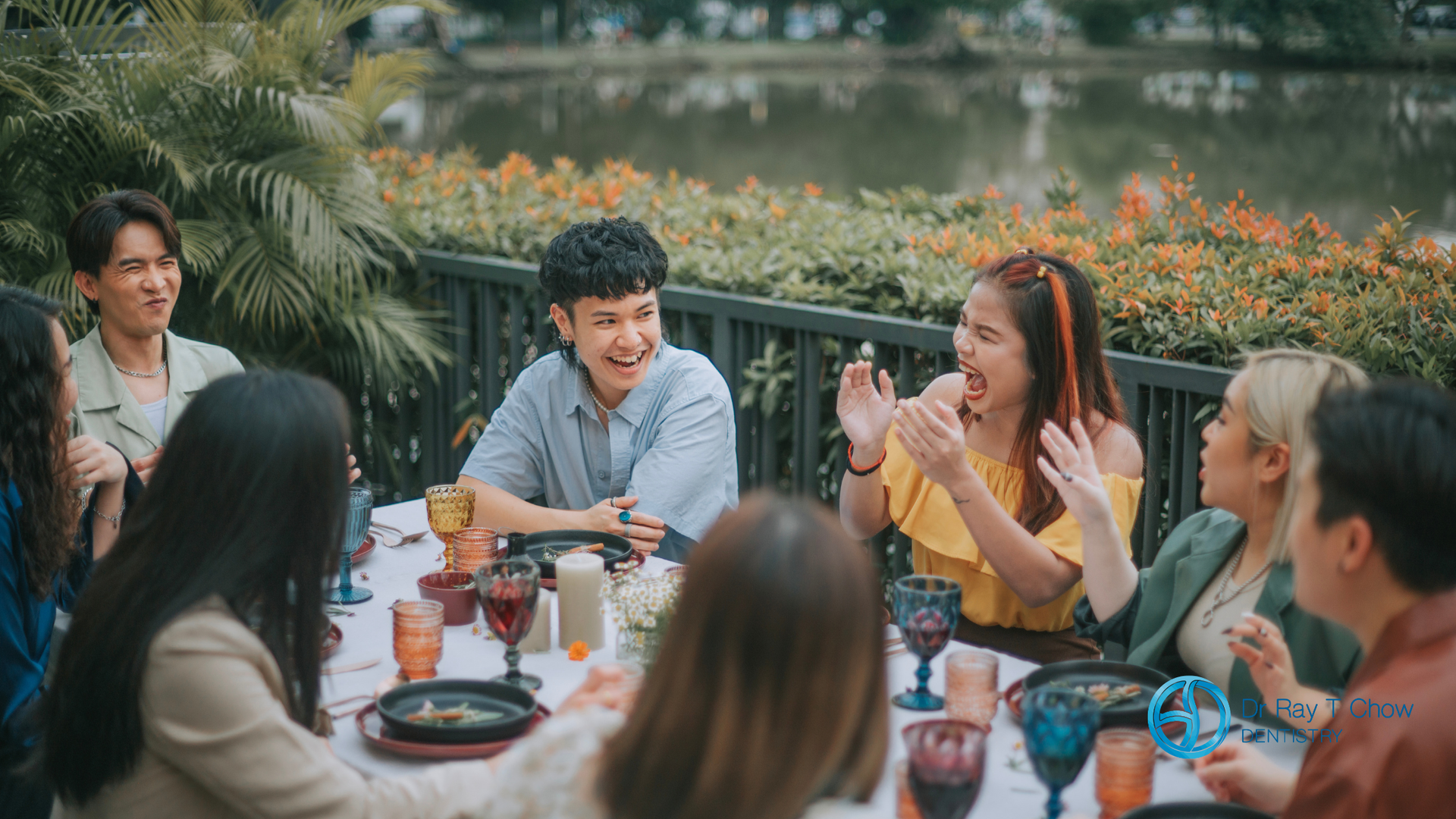 A group of people are sitting around a table eating food.