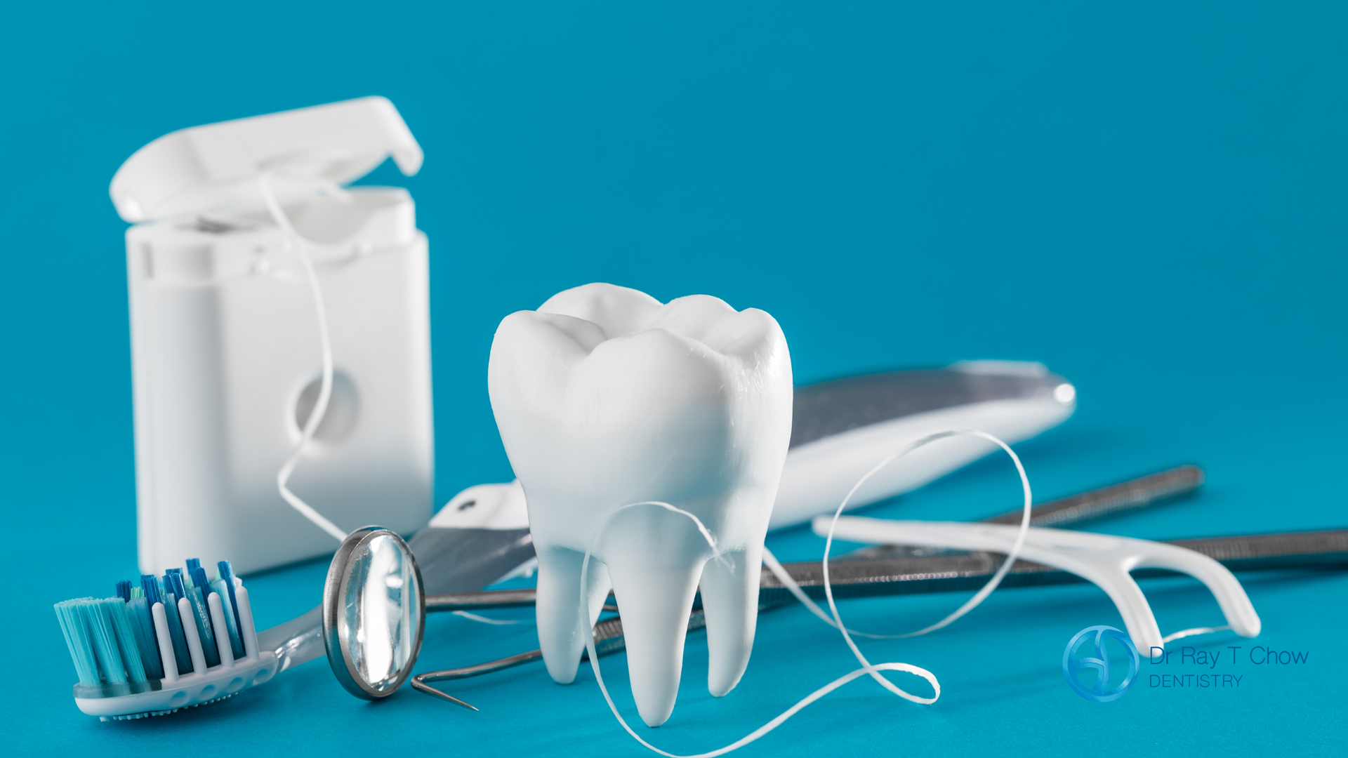 A tooth , toothbrush , floss , mirror and dental instruments on a blue background.