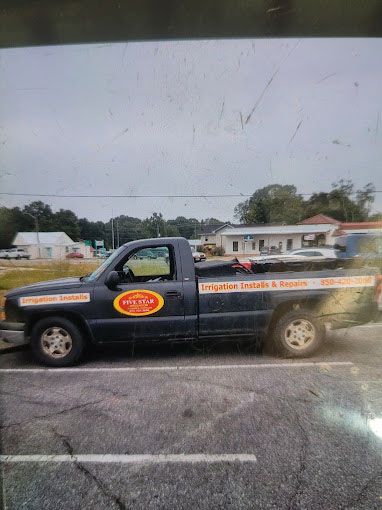 A small truck is parked in a parking lot.