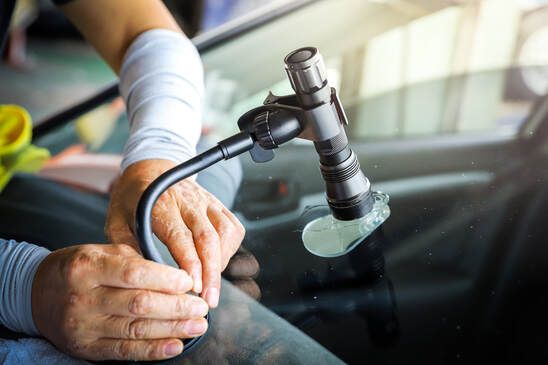 Windshield technician assessing the damage