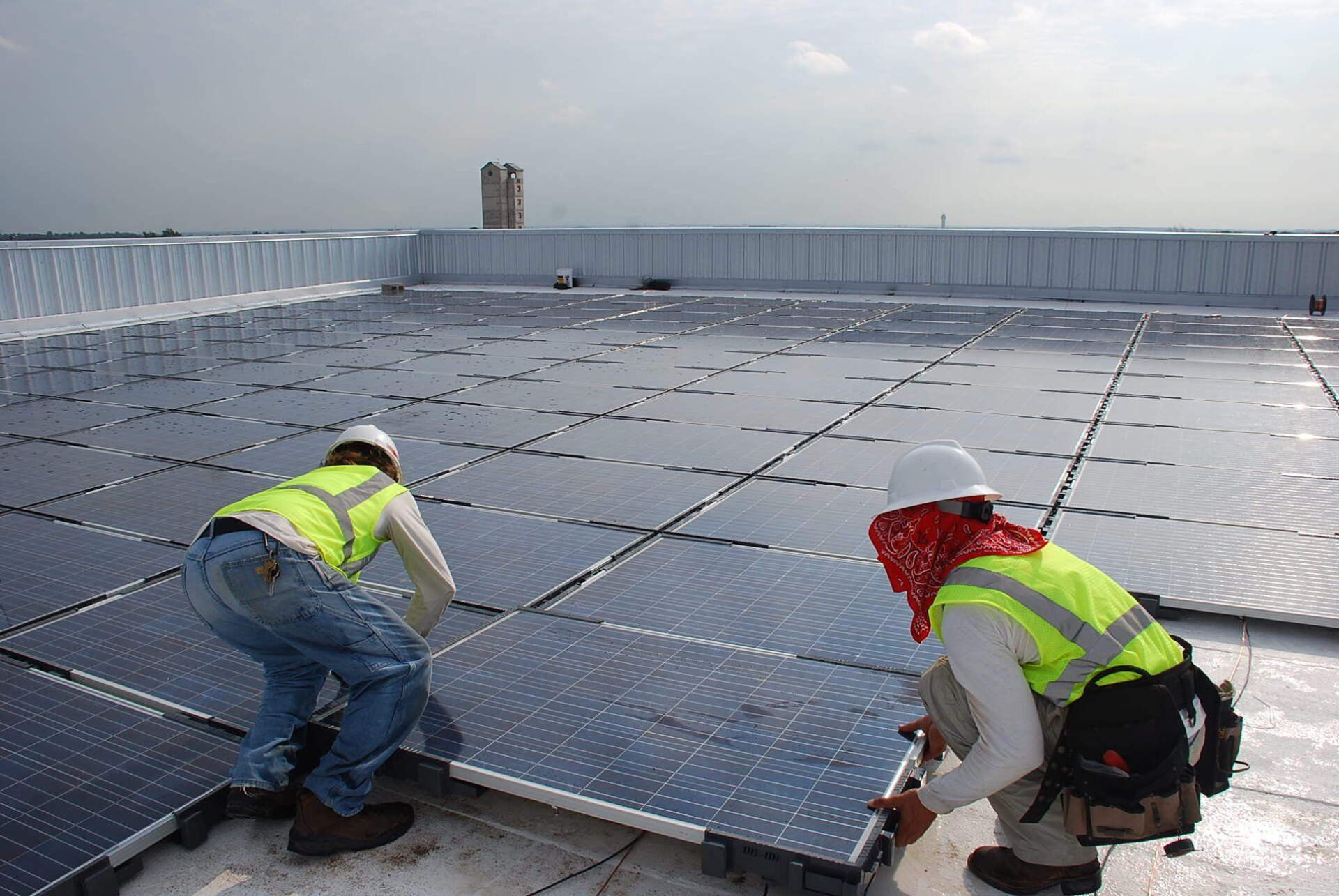 installing new black solar panels on