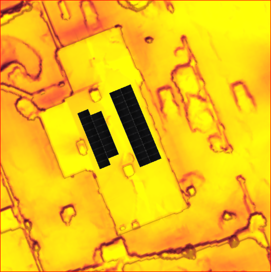 Aerial view of a yellow building with two rectangular solar panel arrays on its roof. The background is a mix of yellow and brown.