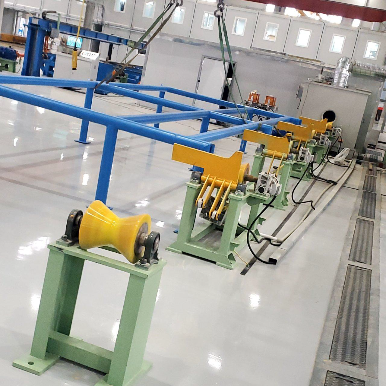 Factory floor with blue frame, yellow and green industrial equipment.