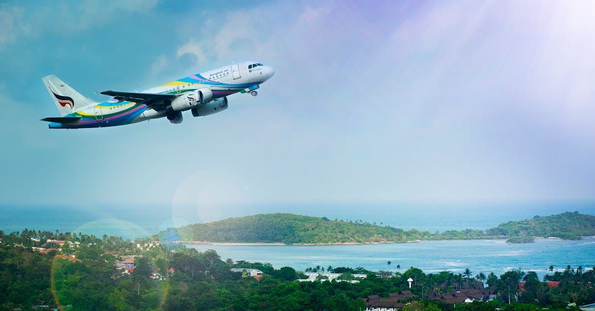 Airplane taking off over a coastal landscape, with a blue sky and green islands.