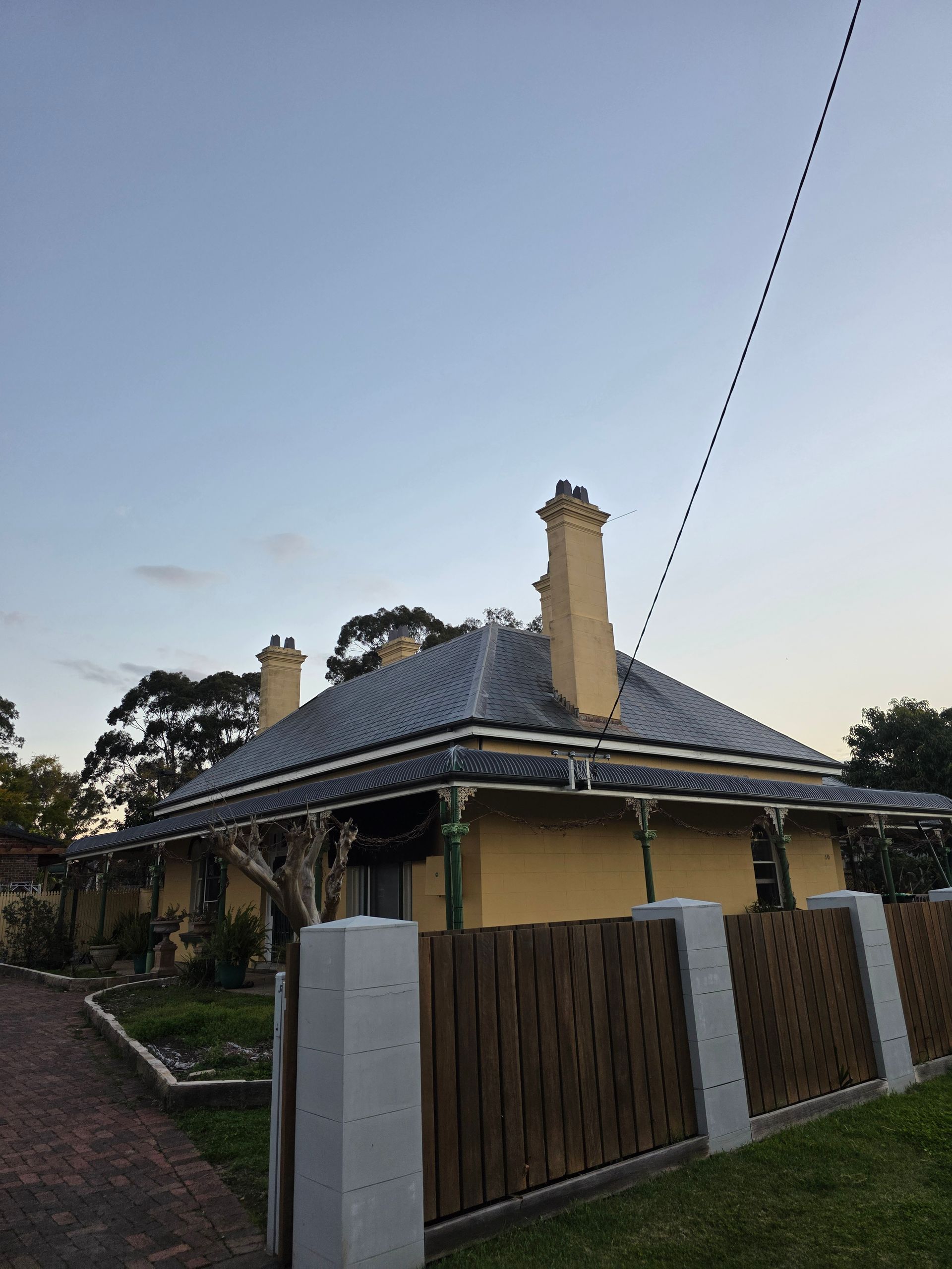 House With a Slate Roof and Chimneys — McLuckie Metal Roofing In Liverpool, NSW