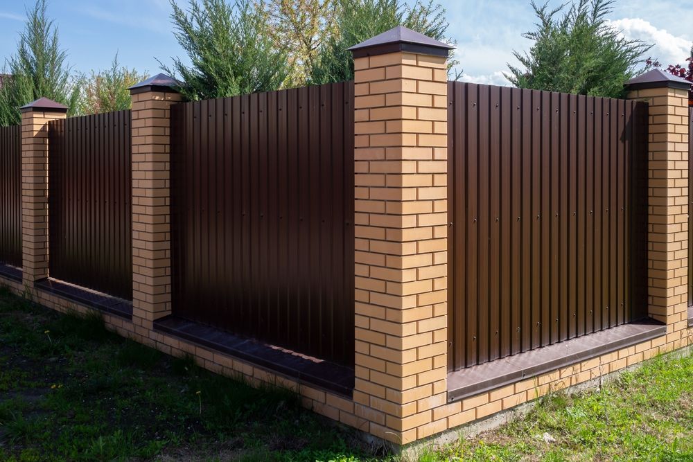 Brown Metal Fence With Brick Posts — McLuckie Metal Roofing In Bankstown, NSW