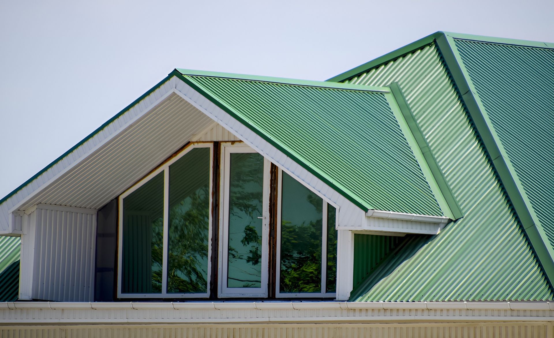 Green corrugated metal roof with white dormer, large windows — McLuckie Metal Roofing In St George, NSW