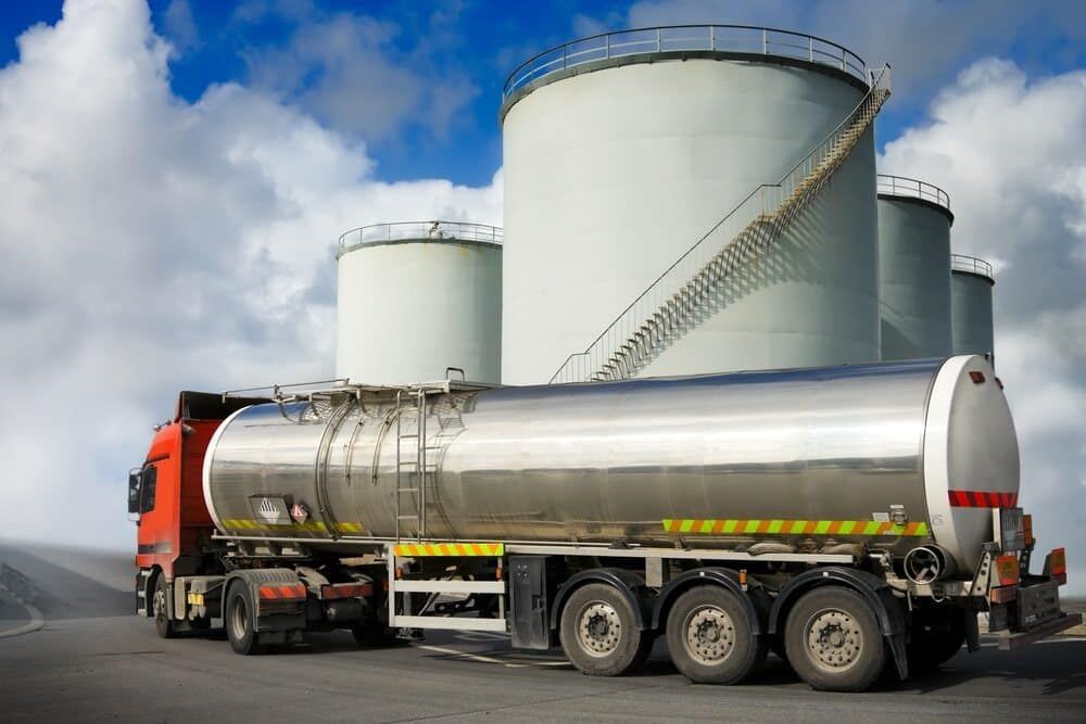 A Tanker Truck Is Parked In Front Of A Row Of Tanks — Tyrepower Innisfail In Mission Beach, QLD