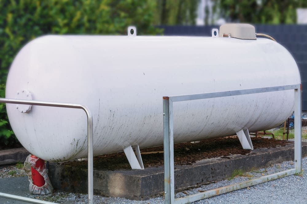 A Large White Tank Is Behind A Metal Fence — Tyrepower Innisfail In Babinda, QLD