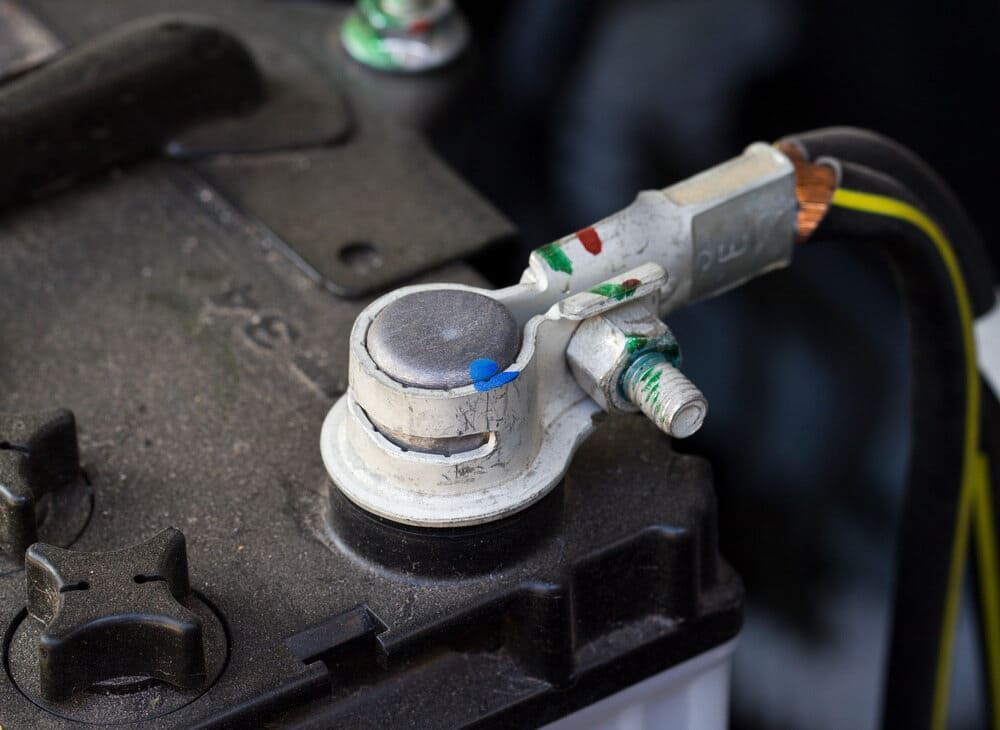 A Close Up Of A Car Battery With A Cable Attached To It — Tyrepower Innisfail In Goondi Bend, QLD