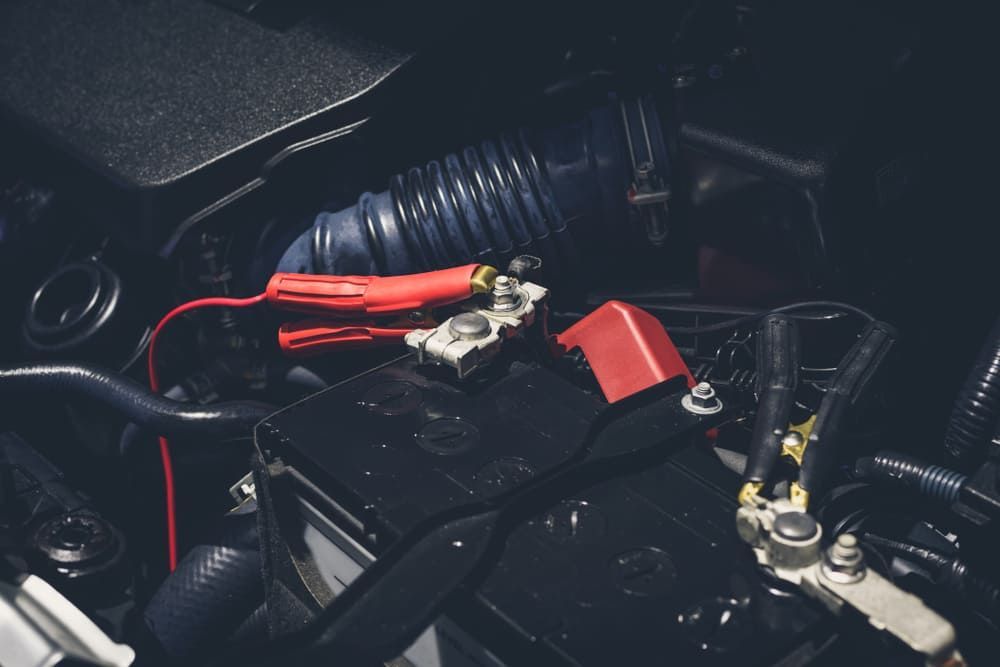 A Close Up Of A Car Battery With A Charger Attached To It — Tyrepower Innisfail In Tully, QLD