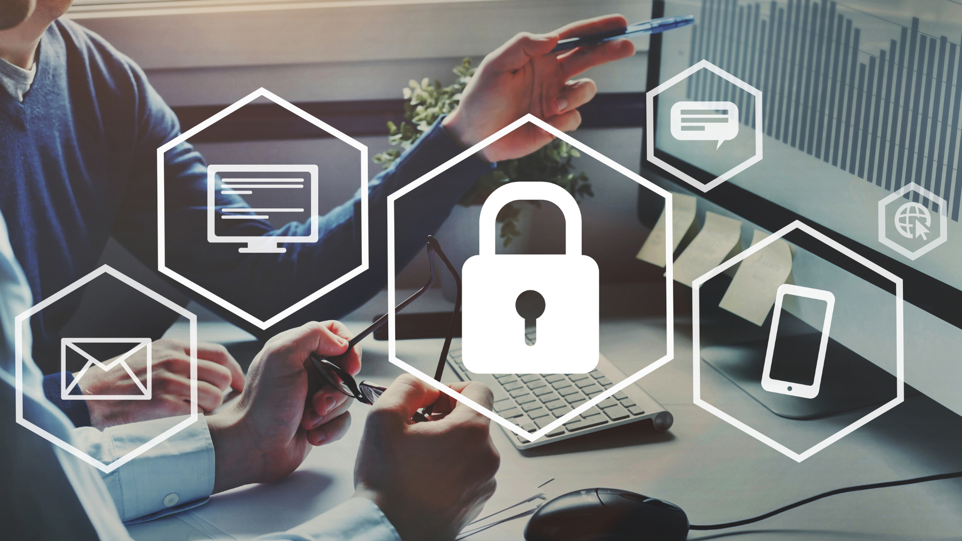 Two people working on a computer with overlaid cybersecurity icons, representing digital security and protection.
