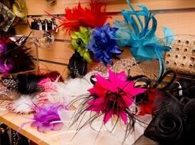 A Bunch Of Hats With Flowers On Them Are Sitting On A Table — Ballistic Chix In Forster, NSW