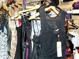 A Black Tank Top Is Hanging On A Wooden Hanger In A Store — Ballistic Chix In Forster, NSW