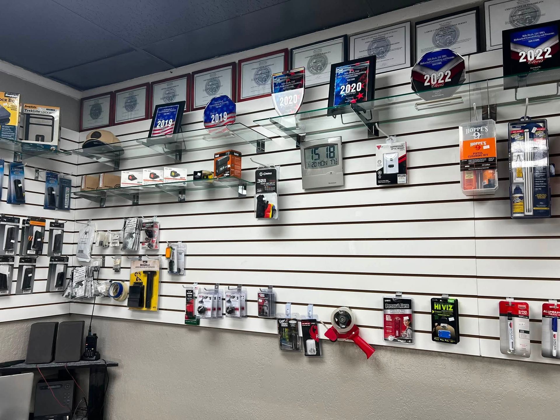 Electronics store wall with rows of packaged accessories and blue product boxes on display racks