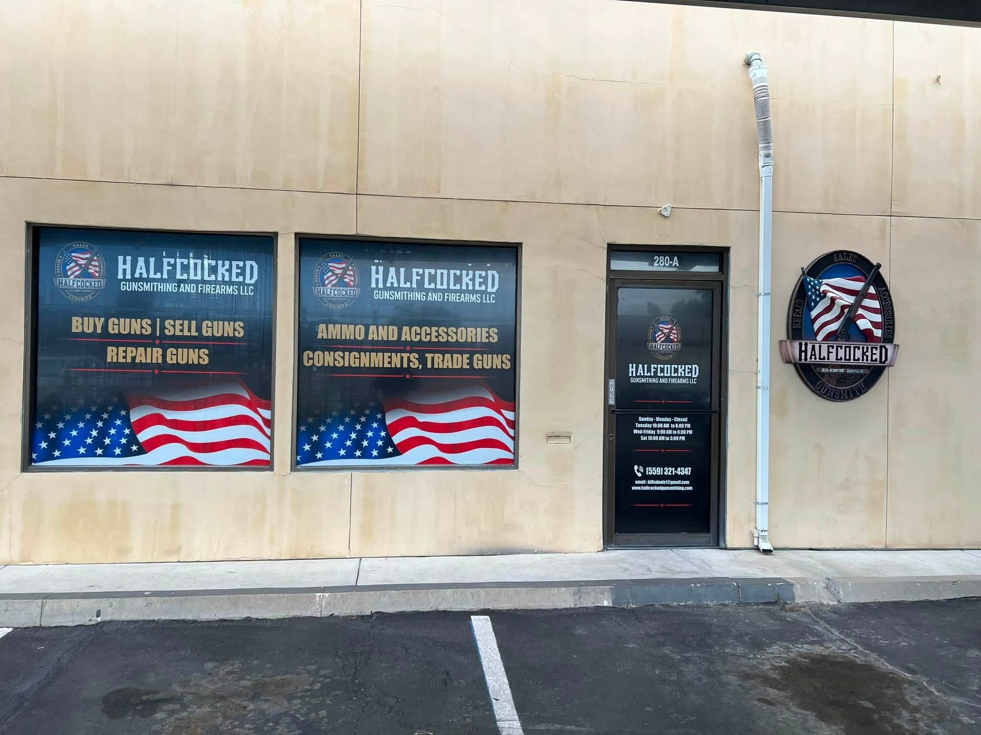 Storefront windows with HALFTIME sports bar banners and a Patriotic-themed sign on a beige exterior wall.