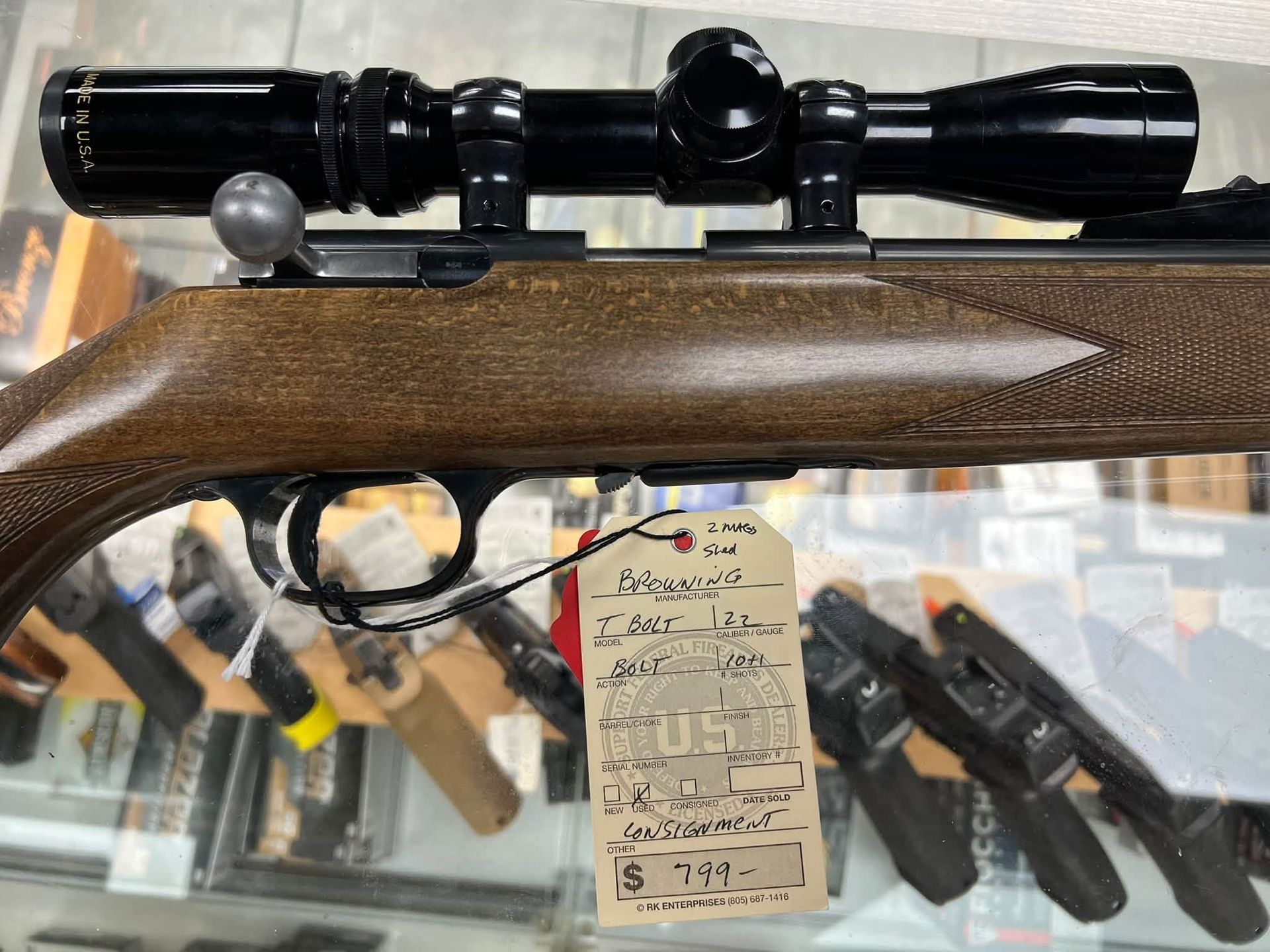 Colt revolver with brown grip and red tag on foam packaging beside Colt box label