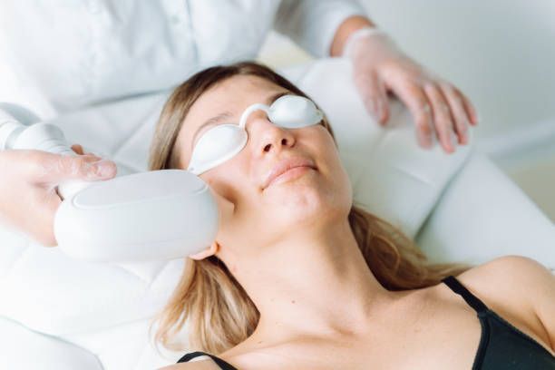A Woman Is Getting A Laser Treatment On Her Face - Latrobe, PA - Laser180