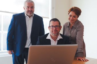 the directors of england and company looking at a laptop