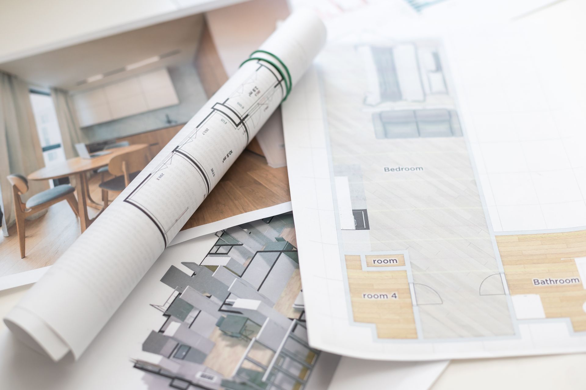 Architectural plans & detailed drawings spread out on a table, showcasing design elements & layout.