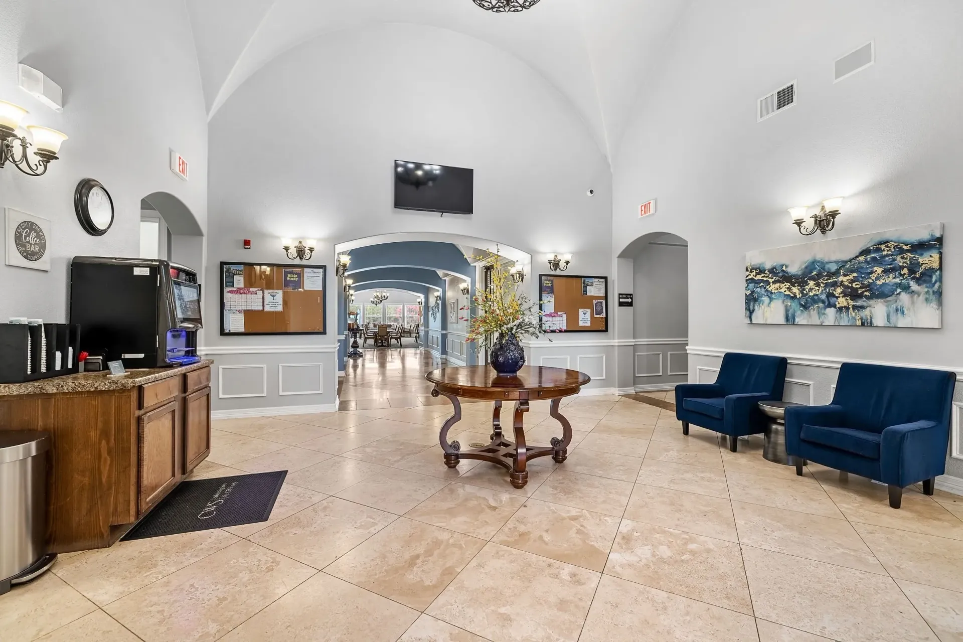 Interior common area with coffee station, seating area, and decorative table.