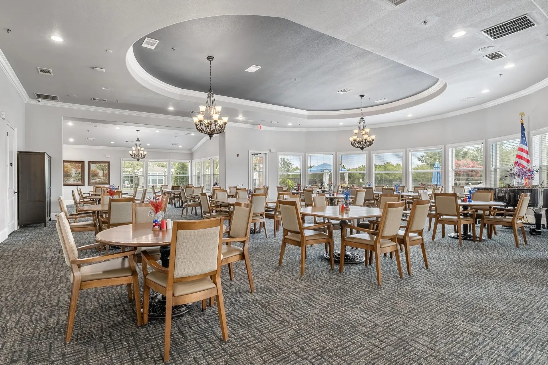 Dining hall with tables and chairs arranged for communal dining.