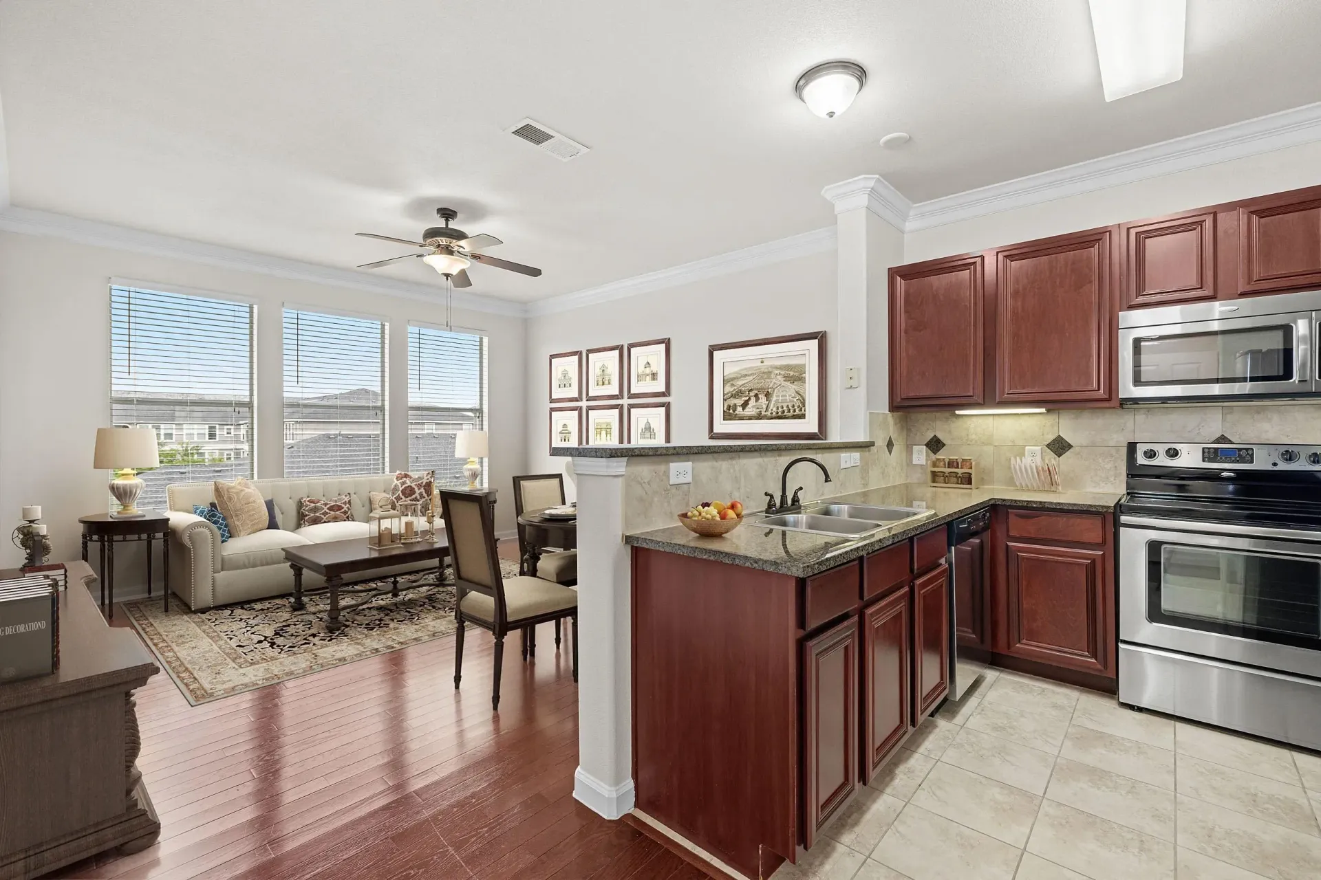Kitchen and living area with sofa, coffee table, dining table, and kitchen island.