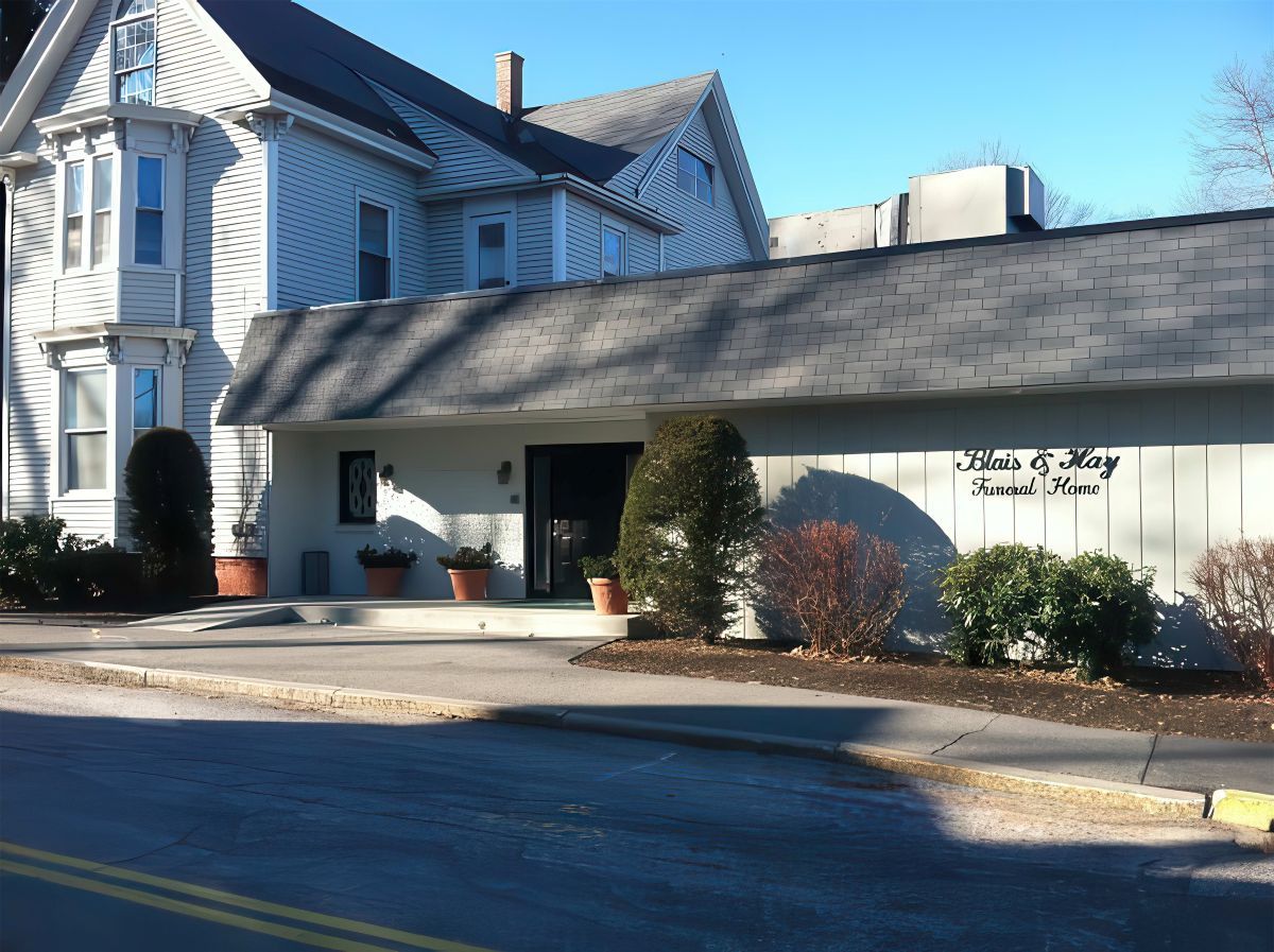 White and gray building with a sign that reads