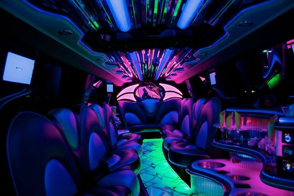 Neon-lit futuristic lounge interior with purple seats, glowing floor, and abstract ceiling lights