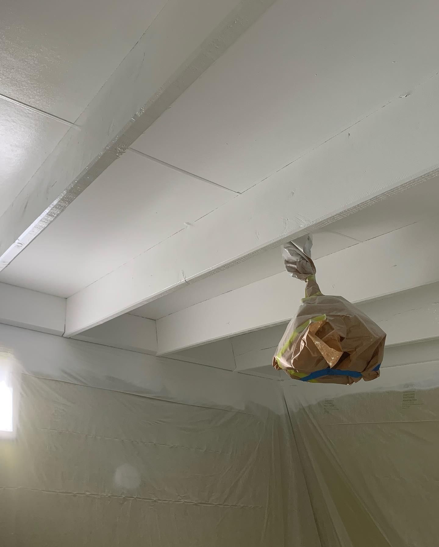 A Bag of Bread is Hanging From the Ceiling of a Room — Holster Painting Contractors In Port Macquarie, NSW