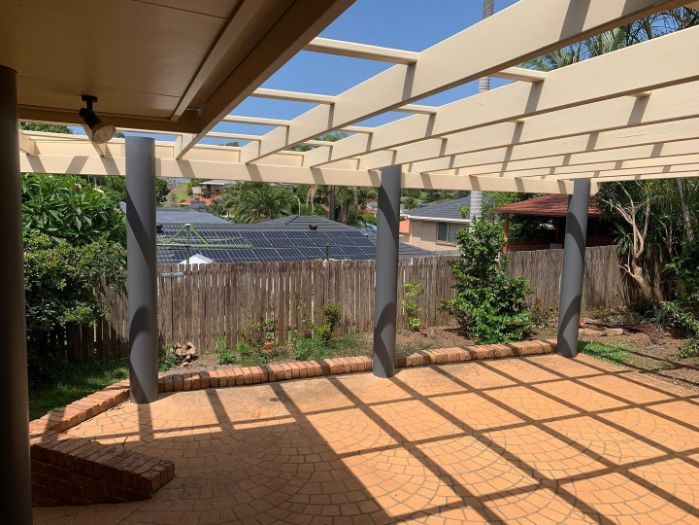 A Patio With a Pergola and a Fence in the Background — Holster Painting Contractors In Beechwood, NSW 