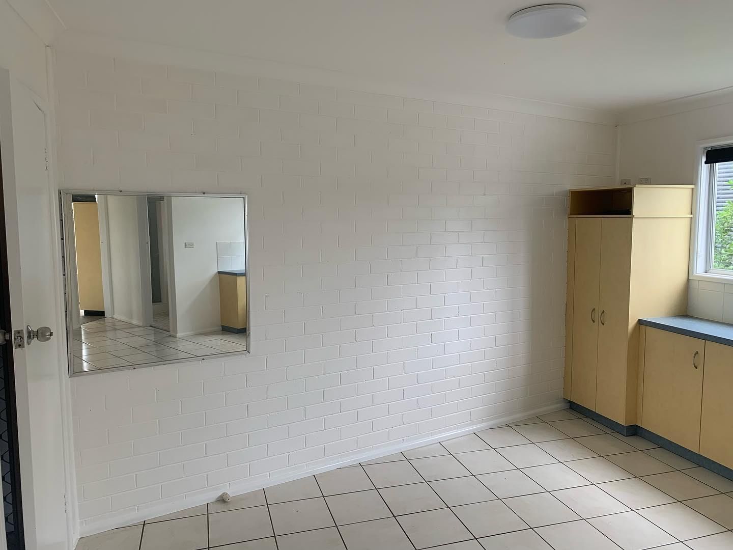An Empty Room With a Large Mirror on the Wall — Holster Painting Contractors In Laurieton, NSW