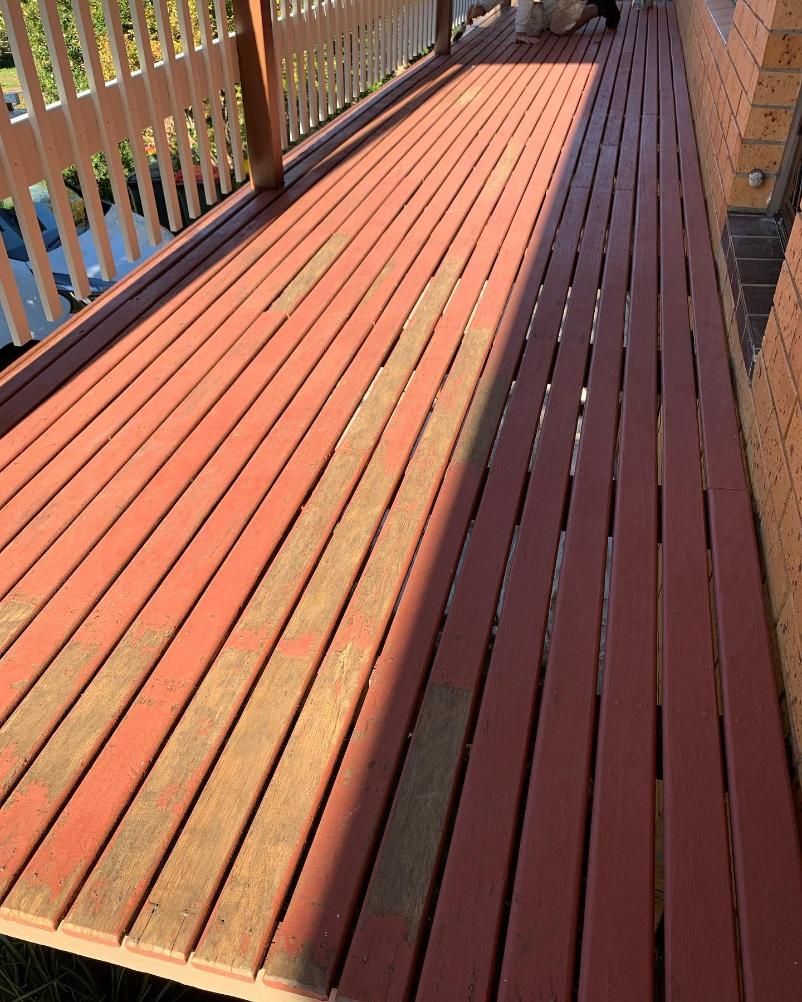 A Red Wooden Deck With a White Railing and a Dog on It — Holster Painting Contractors In Port Macquarie, NSW 