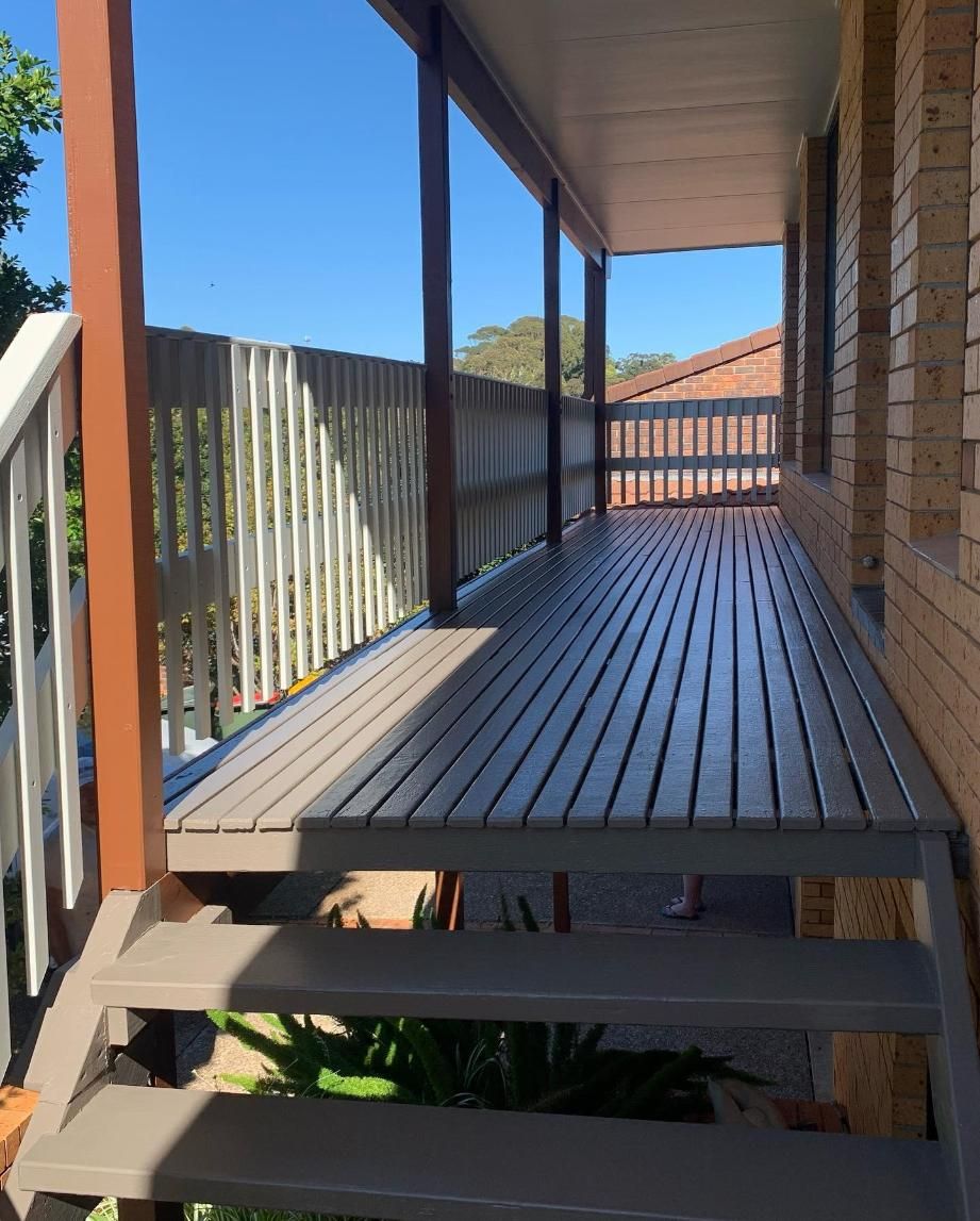 A Wooden Porch With Stairs Leading Up to It — Holster Painting Contractors In Port Macquarie, NSW